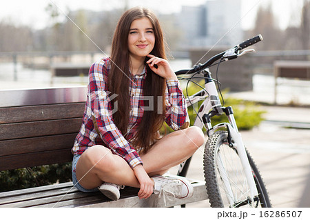 Young beautiful woman on a bicycle 16286507