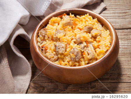 A delicious pilaf in a dish on the old board 16295620