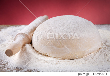 wooden rolling pin with dough and flour wooden rolling pin with dough and flour 16295891