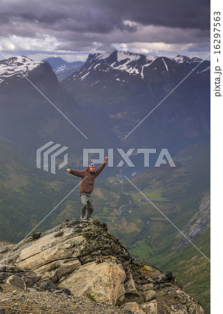 Happy man on the top of a high mountain Happy man on the top of a high mountain 16297563