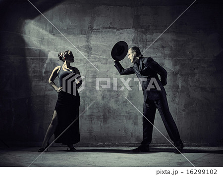 Man and woman dancers, concrete building surroundings 16299102