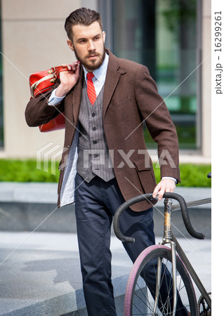 Handsome businessman and his bicycle Handsome businessman and his bicycle 16299261
