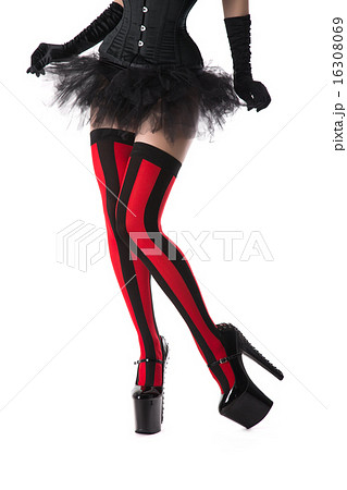 Burlesque woman dressed in striped stockings, corset and mini sk 16308069
