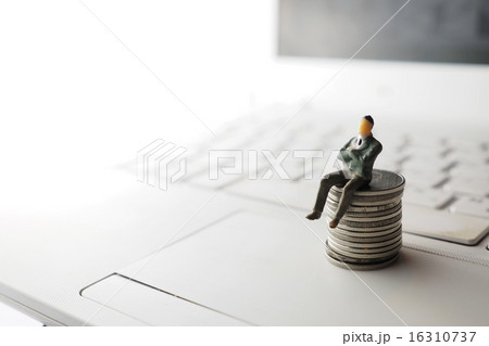 miniature businessman sitting on the coin 16310737