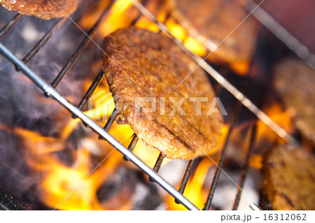 Grilling meat in flames, tasty dinner Grilling meat in flames, tasty dinner 16312062