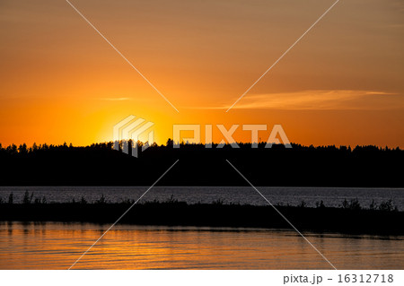 Sunset behind lake and forest 16312718