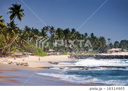 Untouched tropical beach with fishing boat 16314905