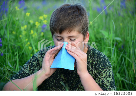 teen boy with allergies in flowering herbs 16323603