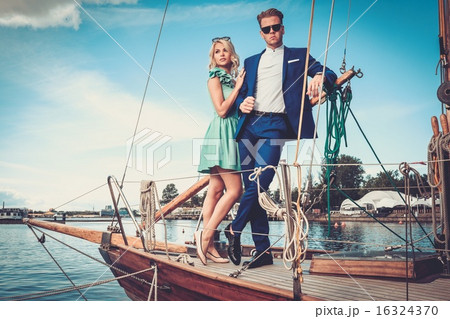 Stylish wealthy couple on a luxury yacht Stylish wealthy couple on a luxury yacht 16324370