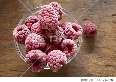 Frozen Raspberries in a glass bowl Frozen Raspberries in a glass bowl 16326770