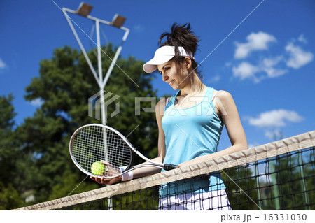 Young woman tennis player on the court Young woman tennis player on the court 16331030