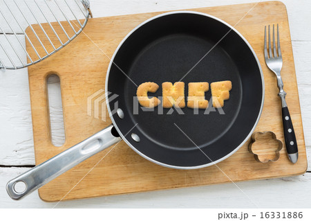 Alphabet crackers word CHEF putting in pan 16331886