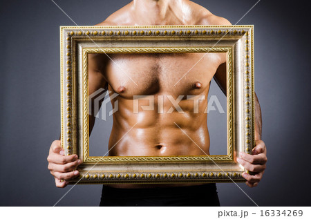 Muscular man with picture frame Muscular man with picture frame 16334269