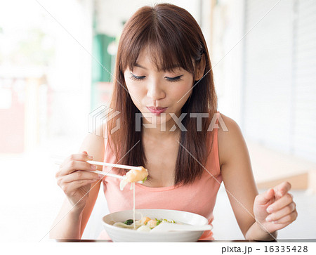 Eating noodles 16335428