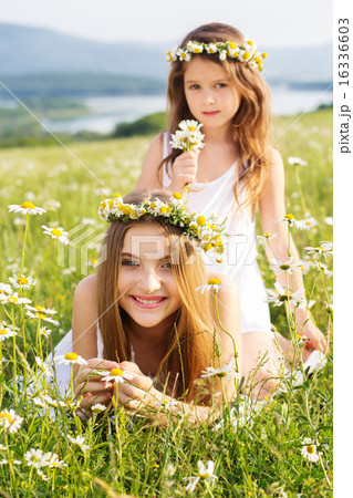 Two pretty girls at meadow with nice mountain view 16336603