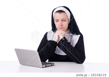 Nun working on laptop - religious concept 16338219