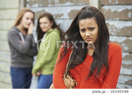Unhappy Teenage Girl Being Gossiped About By Peers Unhappy Teenage Girl Being Gossiped About By Peers 16340586