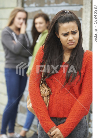 Unhappy Teenage Girl Being Gossiped About By Peers Unhappy Teenage Girl Being Gossiped About By Peers 16340587