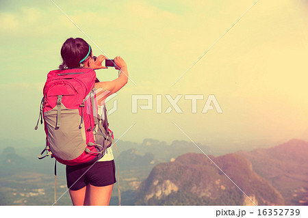 woman hiker taking photo mountian peak 16352739