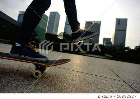 woman skateboarder skateboarding at sunrise city woman skateboarder skateboarding at sunrise city 16352827
