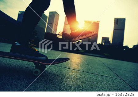 woman skateboarder skateboarding at sunrise city woman skateboarder skateboarding at sunrise city 16352828