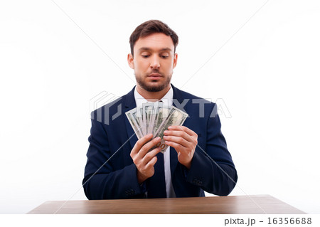 Handsome young man is calculating his savings 16356688