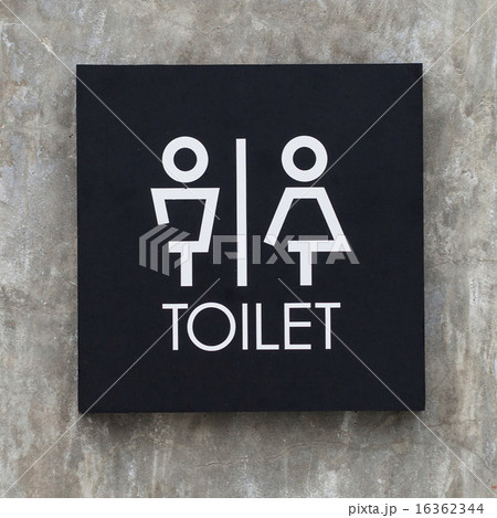 bathroom sign on a cement wall 16362344