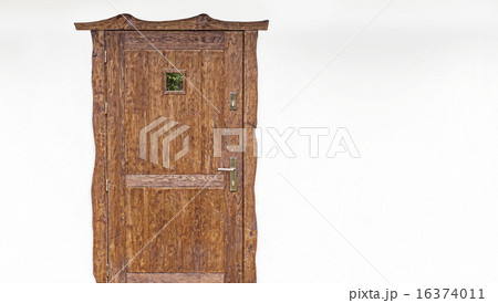 Wooden door on the white house facade. Wooden door on the white house facade. 16374011