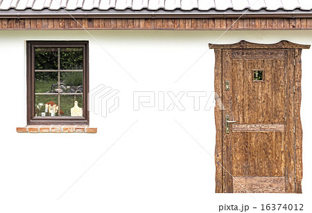 Door and window on the facade of a house. 16374012