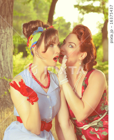 two girls gossiping 16375437