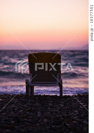 Lonely sun bed on sea coast in dusk Lonely sun bed on sea coast in dusk 16377501