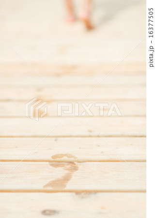 Closeup on wet footsteps on bridge 16377505