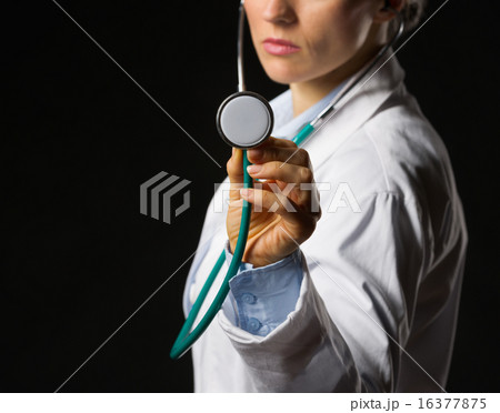 Closeup on medical doctor woman using stethoscope isolated on bl 16377875