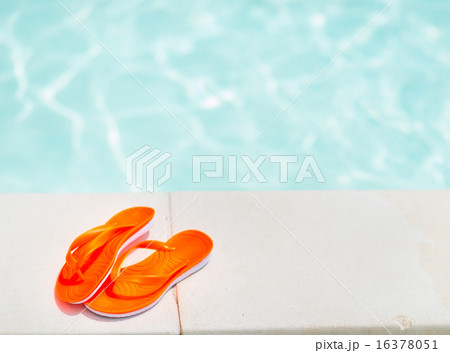 Closeup on sandals laying near swimming pool Closeup on sandals laying near swimming pool 16378051