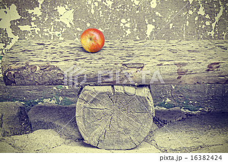 Ripe apple on old wooden bench, retro toned. 16382424