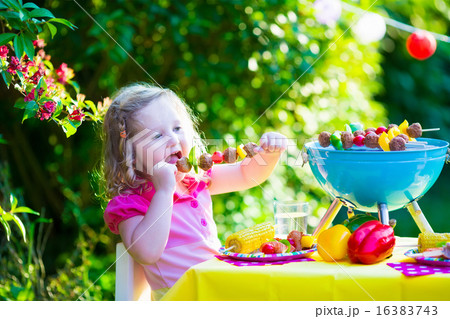 Little girl at garden grill party Little girl at garden grill party 16383743