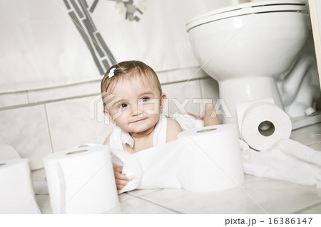 Toddler ripping up toilet paper in bathroom Toddler ripping up toilet paper in bathroom 16386147