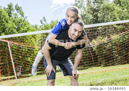 teenager girl with his father play soccer in a beautiful day 16386491