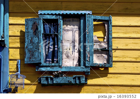 blue wood venetian blind and a yellow wall 16393552