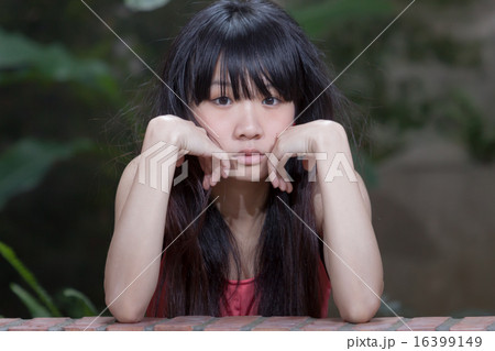 Asian girl by plants Asian girl by plants 16399149