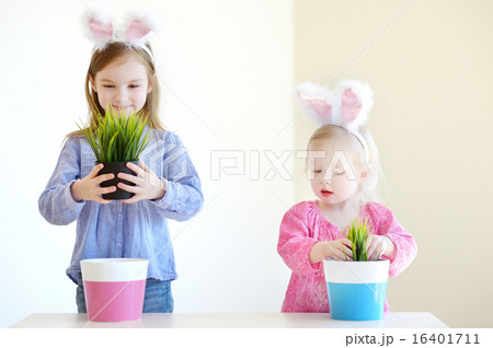Two sisters wearing bunny ears on Easter 16401711