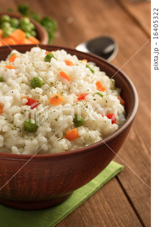 bowl full of rice on wood 16405322