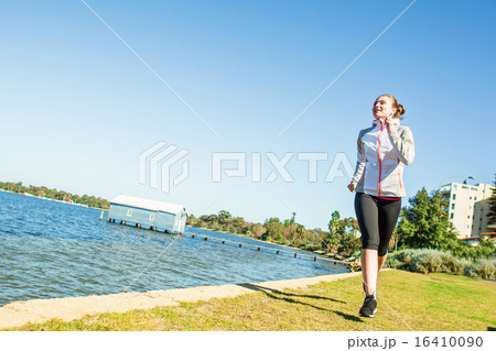 Young woman jogging near the river at sunny day Young woman jogging near the river at sunny day 16410090