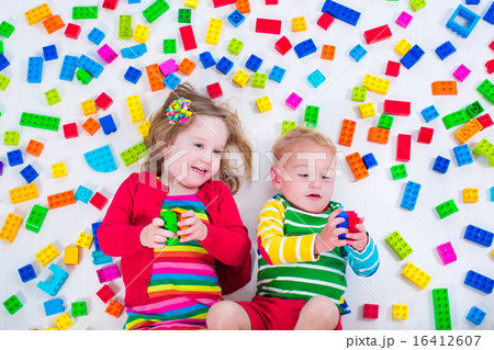 Kids playing with colorful blocks Kids playing with colorful blocks 16412607