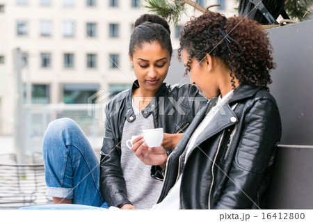 Best friends drinking coffee in city Best friends drinking coffee in city 16412800