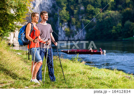 Man and woman hiking at Danube river in summer Man and woman hiking at Danube river in summer 16412834