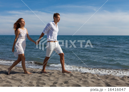 happy couple in love walking on the beach 16416047