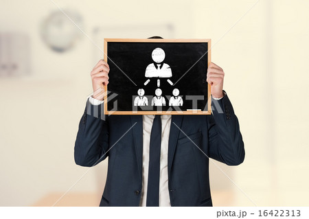 Composite image of businessman holding board 16422313