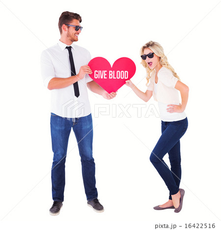 Composite image of cool young couple holding red heart Composite image of cool young couple holding red heart 16422516