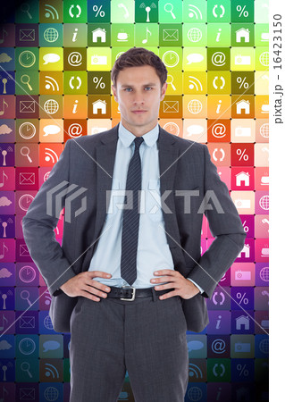 Composite image of serious businessman with hands on hips Composite image of serious businessman with hands on hips 16423150
